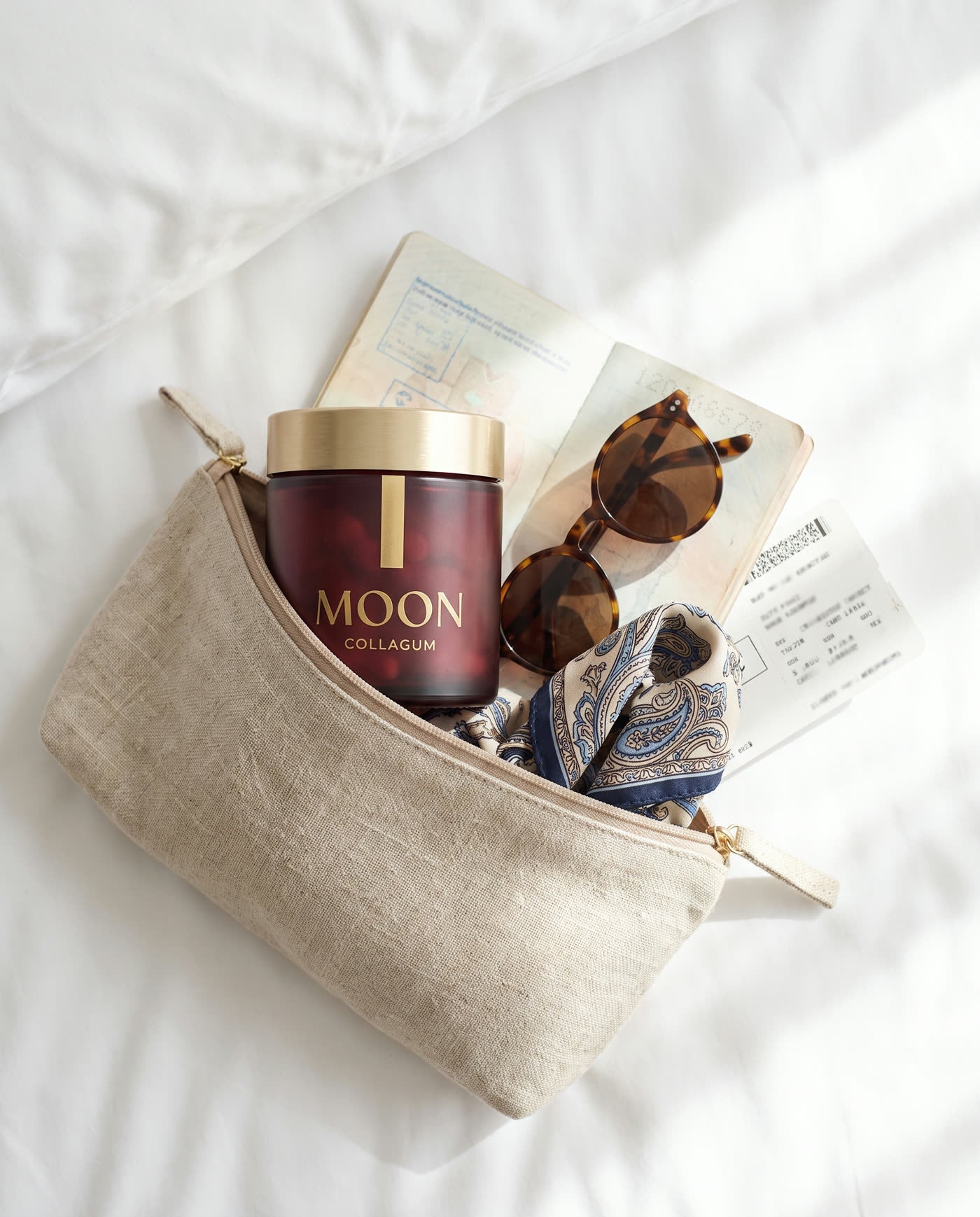 The CollaGum jar in a linen travel pouch