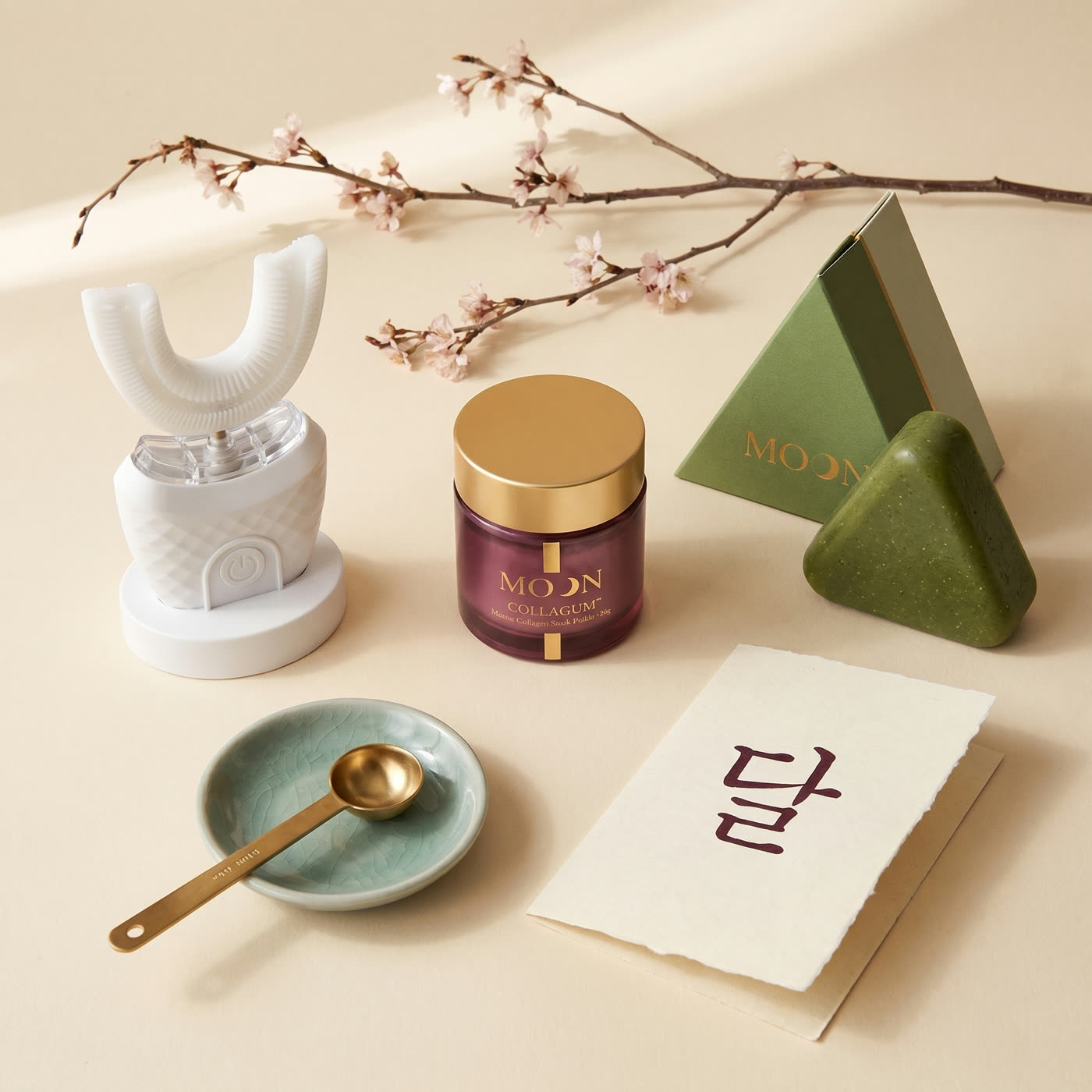 MOON products on a cream table with cherry blossom